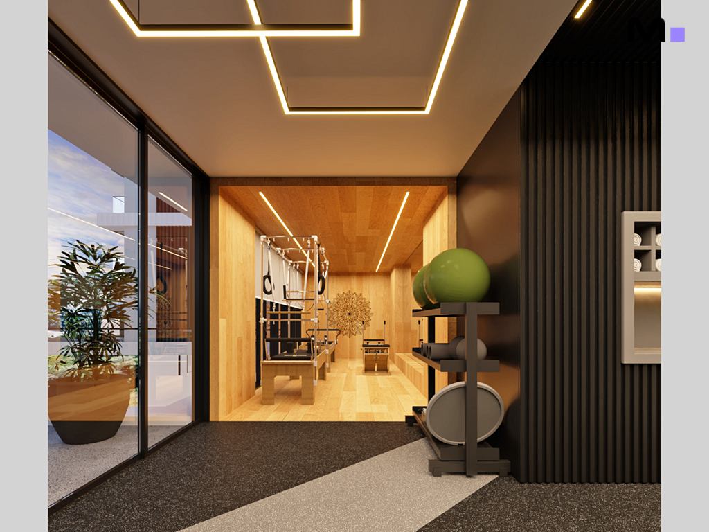 Estúdio de pilates moderno com equipamentos e luzes decorativas no Habitat Praia Brava.