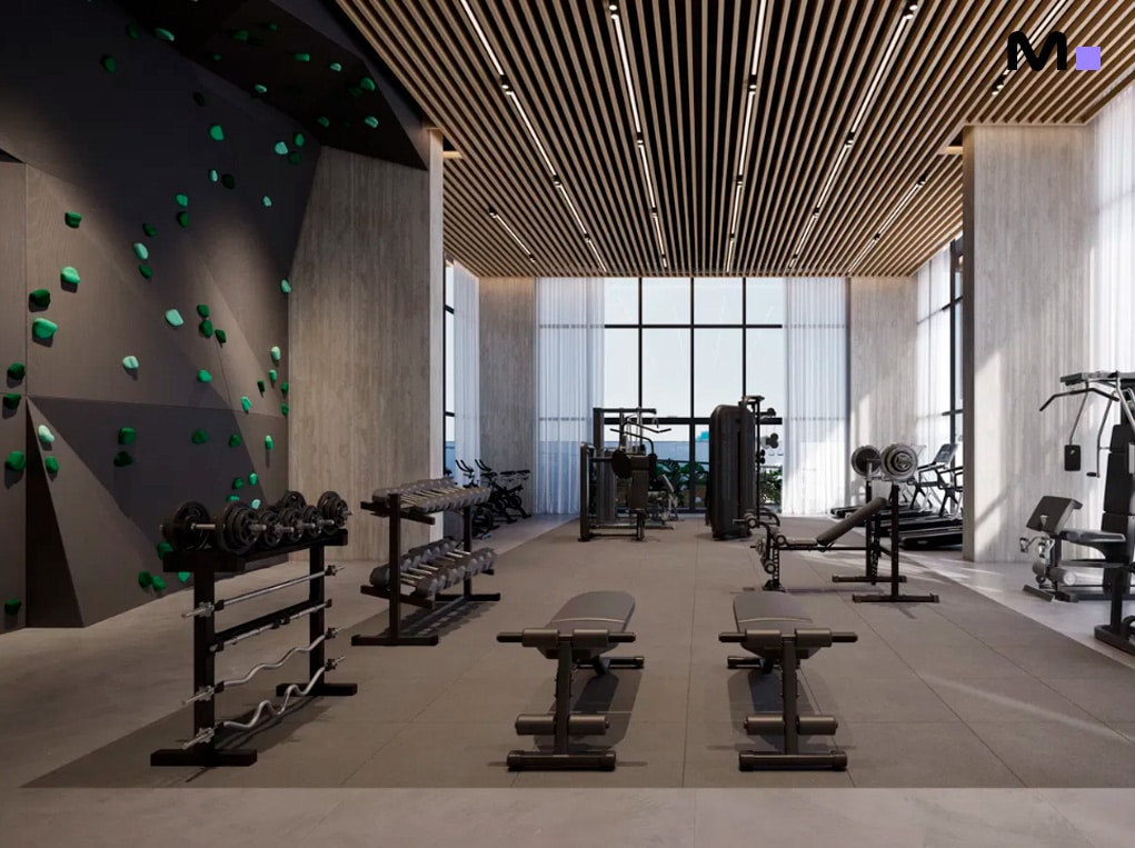 Academia moderna e bem iluminada com equipamentos de ginástica e parede de escalada.
