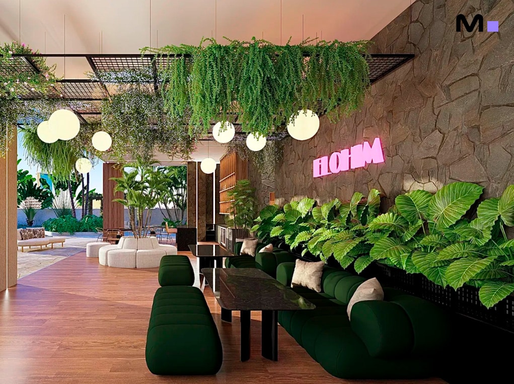 Interior moderno do Elohim Residencial Club com plantas, sofás verdes e iluminação aconchegante.