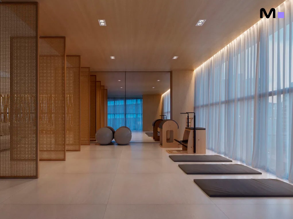 Sala de ginástica moderna com espelhos e equipamentos de pilates, parte do Down Town by Housi.