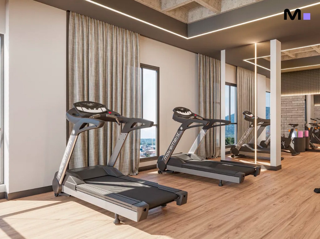 Esteira em academia moderna no Minuannon Residencial. Espaço fitness bem iluminado.