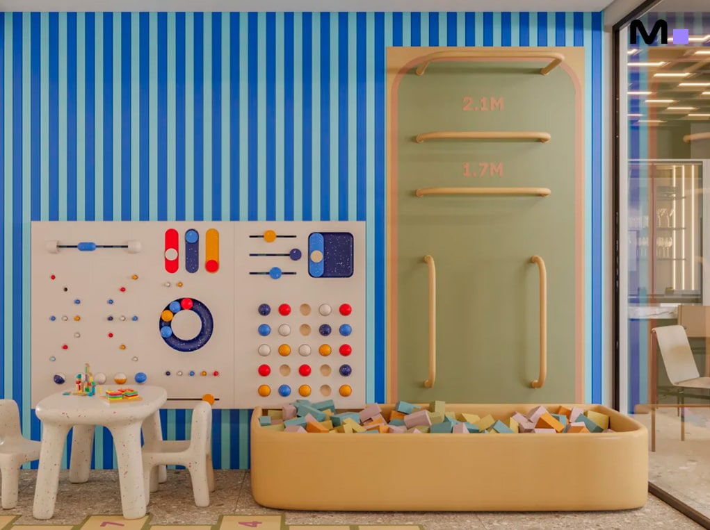 Sala de jogos infantil colorida com piscina de bolinhas, parede interativa e mesa. Axion Towers.