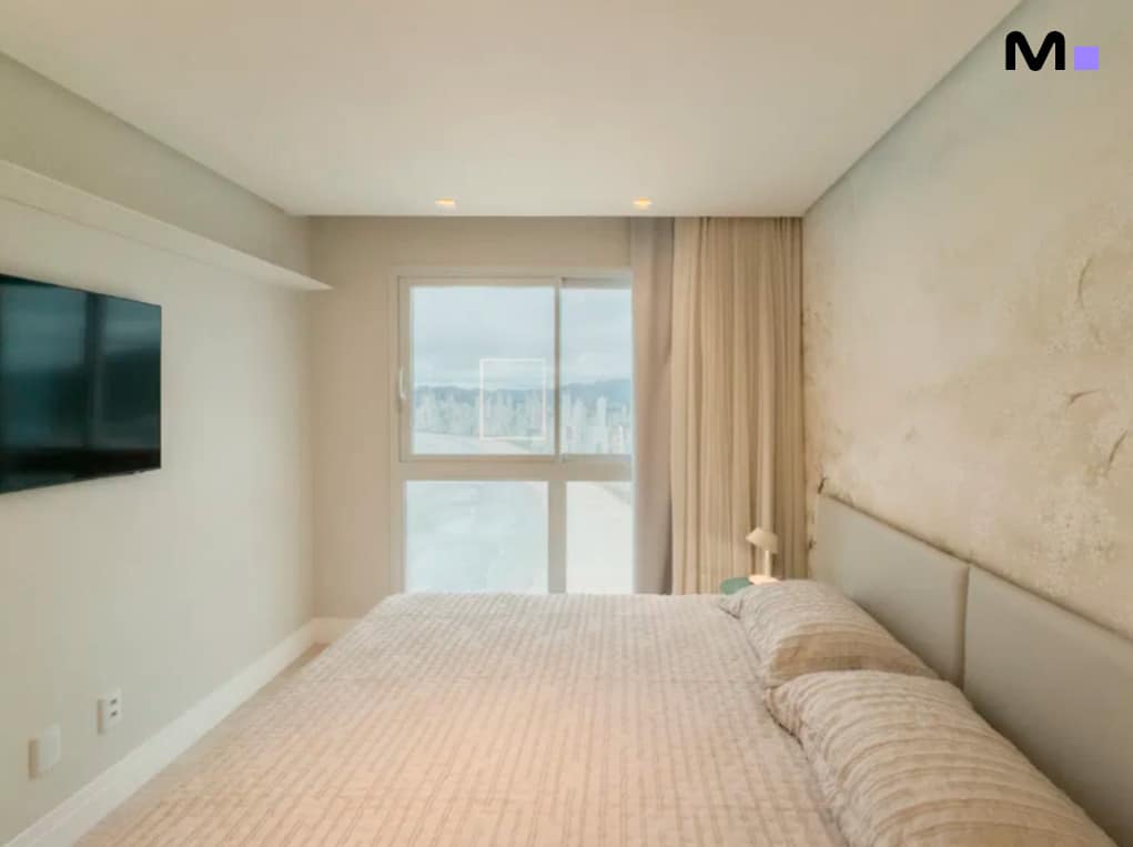 Quarto iluminado no Infinity Coast Residence com vista para a cidade.