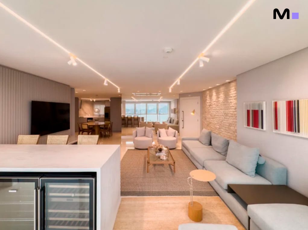 Sala de estar moderna e luminosa no Infinity Coast Residence, com design elegante e vista ampla.