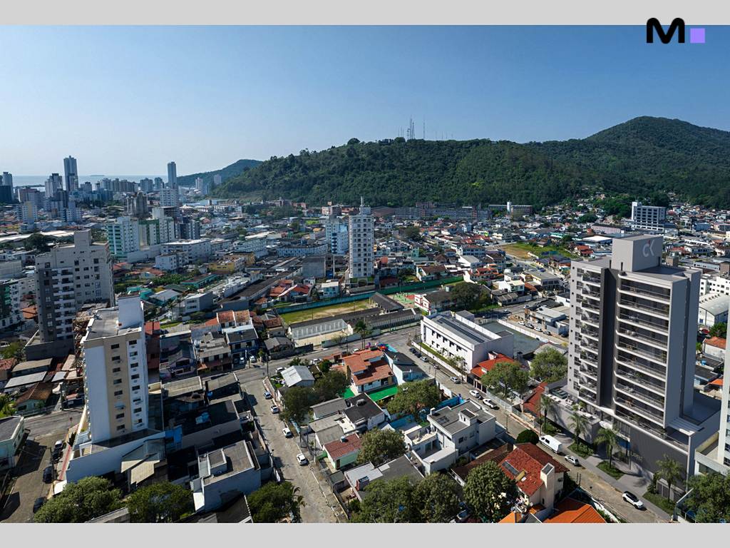 Vista aérea da Urbe Residence em Itajaí, com a cidade e montanhas ao fundo.