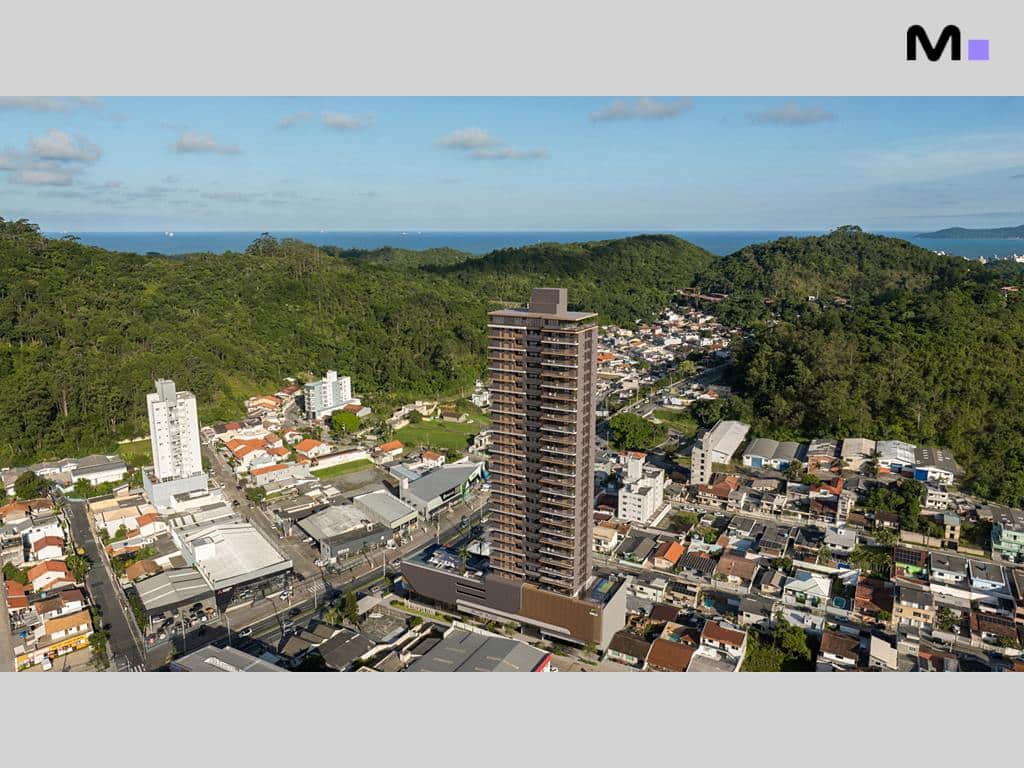 Vista aérea do Metropolitan Modern Residences, um edifício alto em área urbana arborizada.