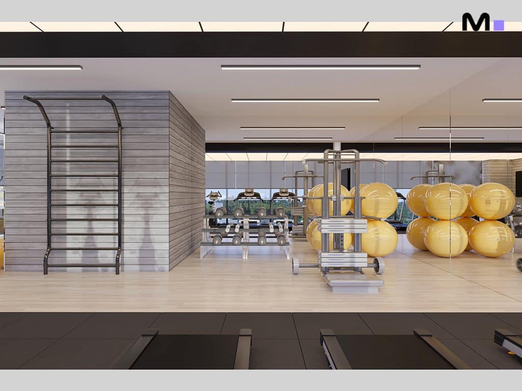 Academia moderna com equipamentos e bolas amarelas.