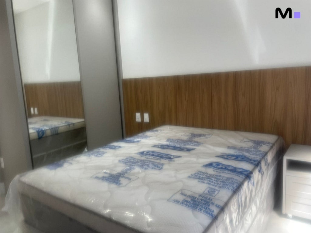 Quarto mobiliado no Condomínio House Haras com cama e espelho.