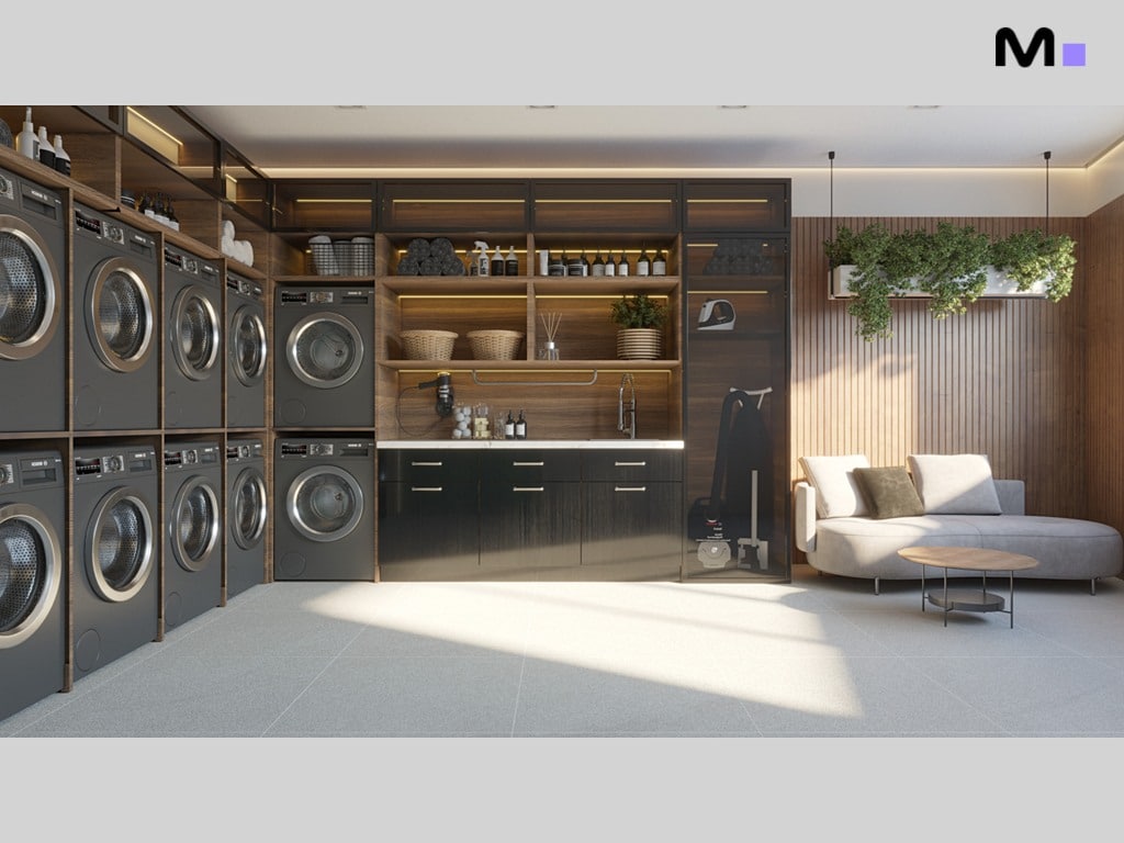 Lavanderia moderna e organizada com máquinas de lavar e secar empilhadas, armários e área de descanso. Residência Torre Del Mare.