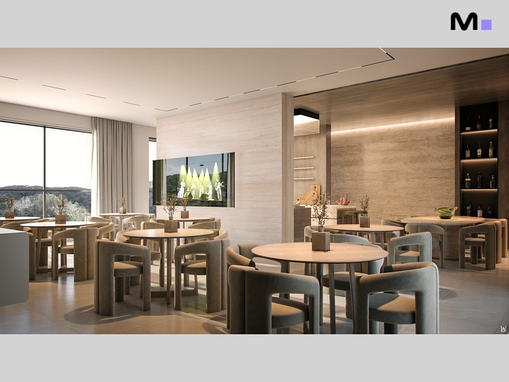 Interior do Nilo Residence: mesas redondas com cadeiras aconchegantes, iluminação suave e design moderno.