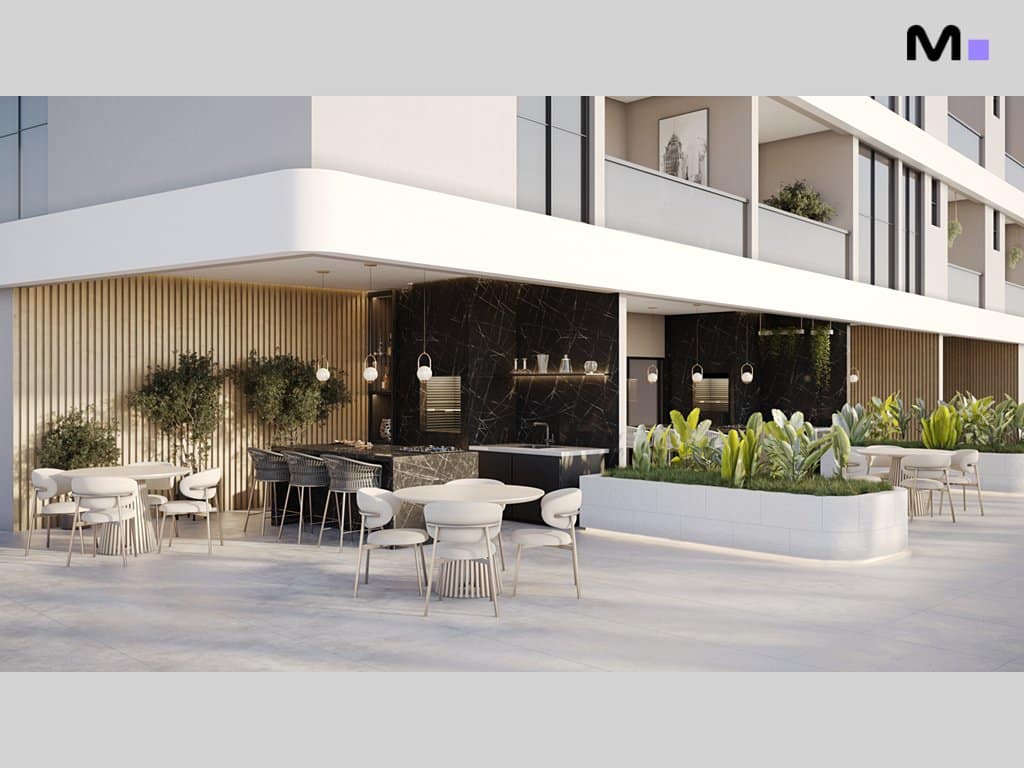 Área externa do Torre Del Mare Residence com mesas, cadeiras e cozinha gourmet moderna.