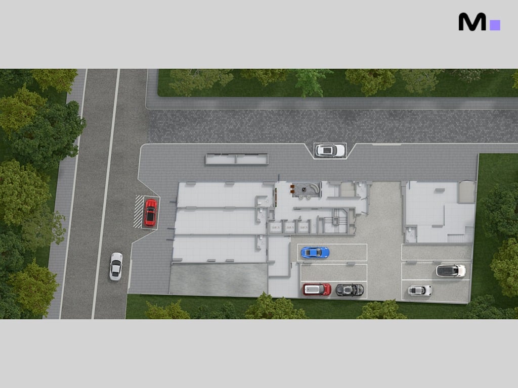 Planta baixa arquitetônica detalhada mostrando layout de edifício com estacionamento e áreas verdes.