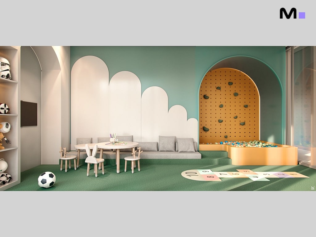 Sala de jogos infantil da Nilo Residence com mesa, parede de escalada e piscina de bolinhas.