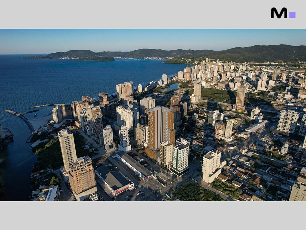 Vista aérea da cidade costeira com novos edifícios Vibra Phacz Home em destaque.