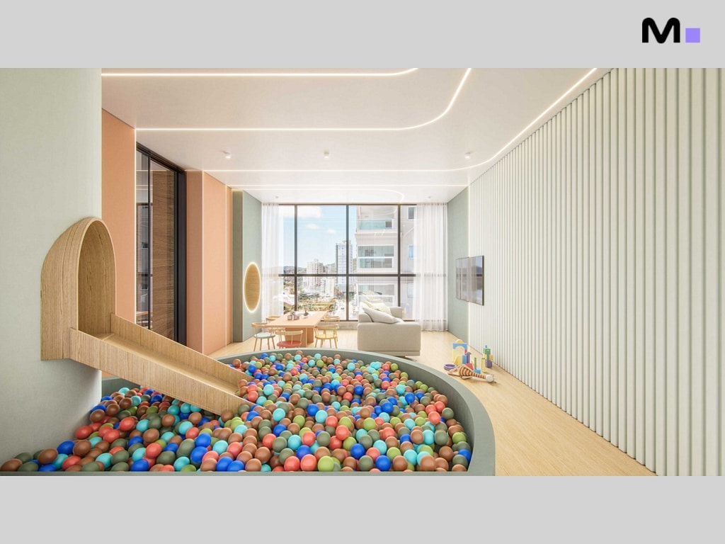 Sala de jogos infantil no Hudson Park Residence com piscina de bolinhas colorida e escorrega de madeira.