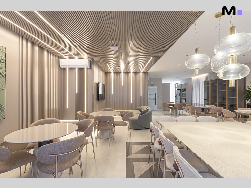 Interior moderno do Residencial Vila Aurora com mesas e iluminação elegante.