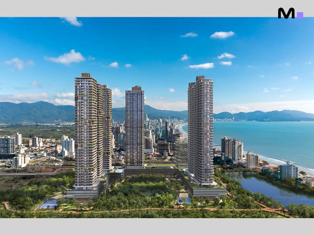 Residência Lagom Perequê: Vista aérea dos edifícios modernos com paisagem exuberante e oceano ao fundo.