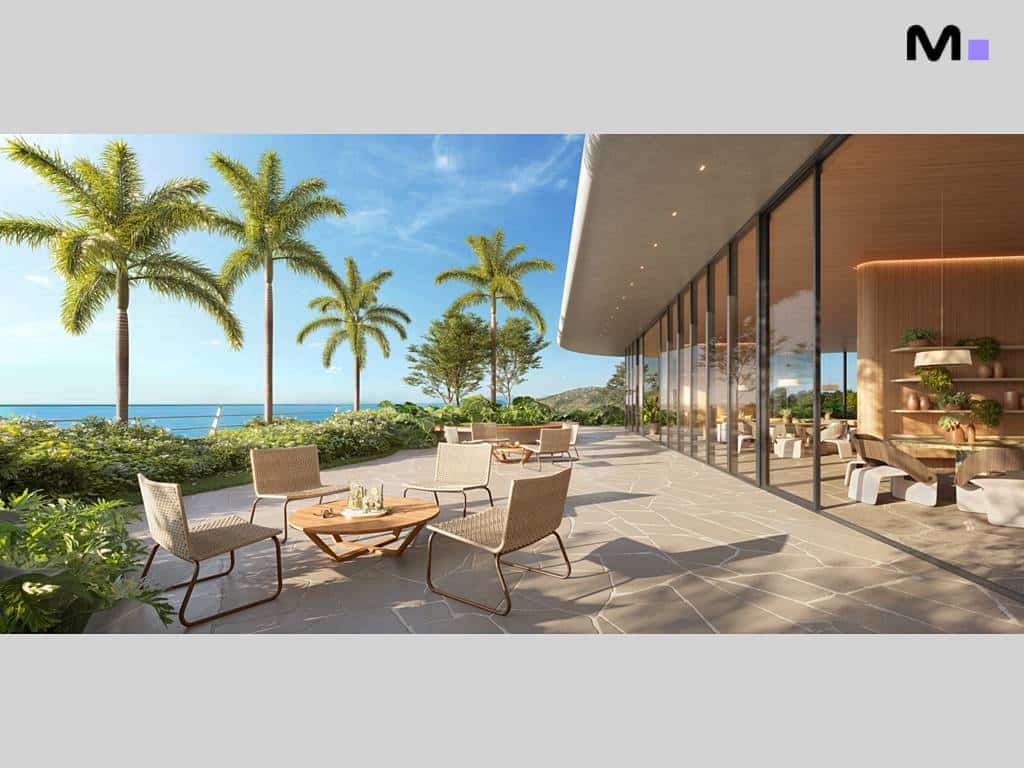 Varanda do Lagom Perequê Residence com vista para o mar e palmeiras.