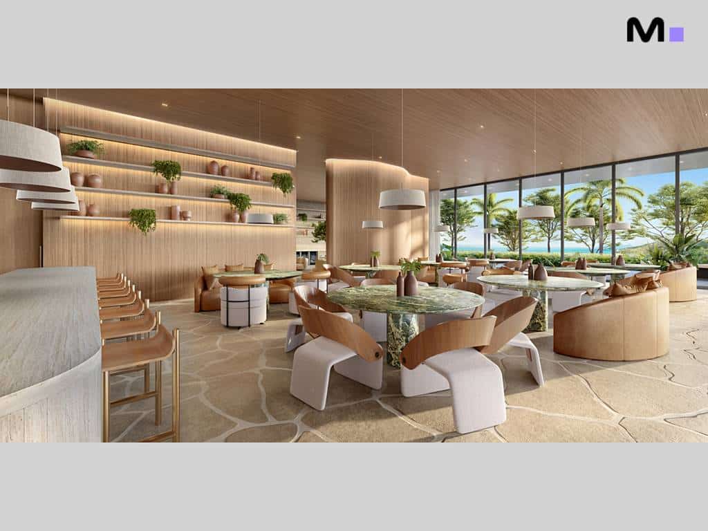 Interior elegante do Lagom Perequê Residence com mesas, cadeiras modernas e vista para o mar.