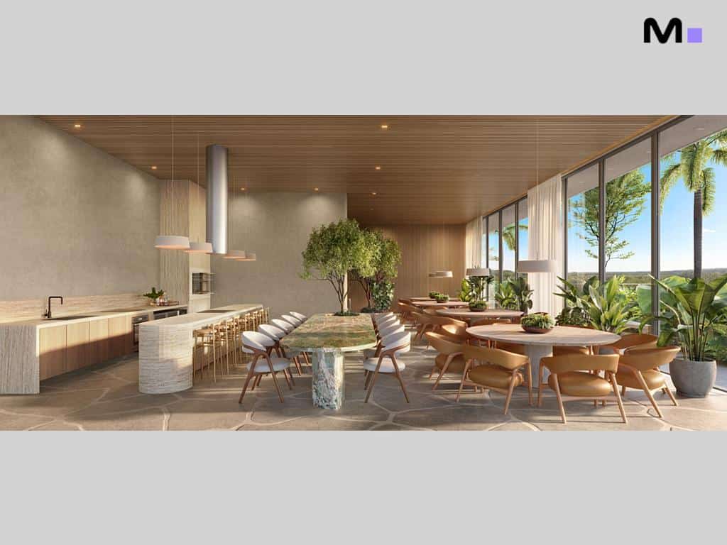 Interior do Lagom Perequê Residence com cozinha, mesas e vista para a natureza.