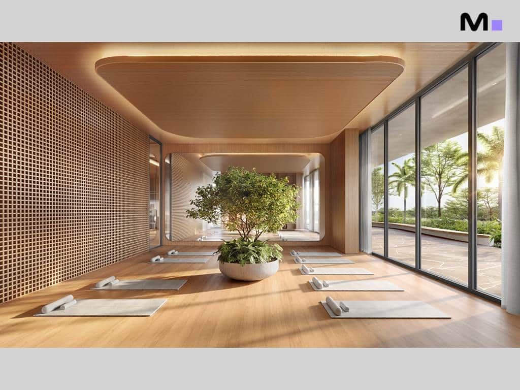 Sala de yoga no Lagom Perequê Residence com mats, planta central e janelas amplas.